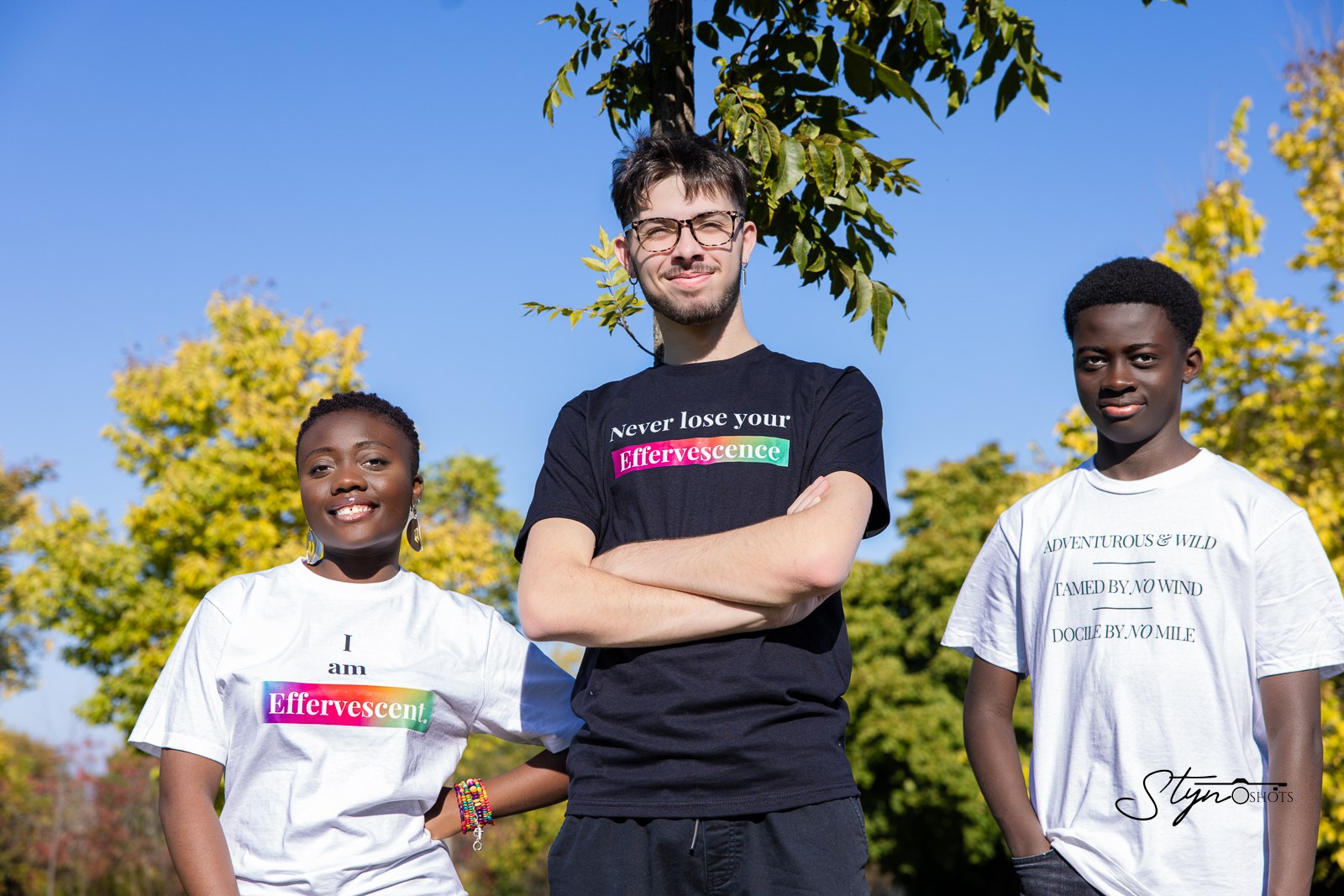 Three models wearing Effervescence tees outdoors — I am Effervescent, Never Lose Your Effervescence, and Adventurous and Wild